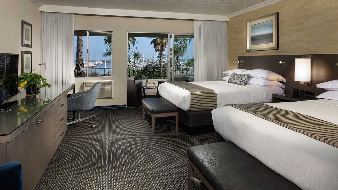 Two beds in hotel room with harbor view