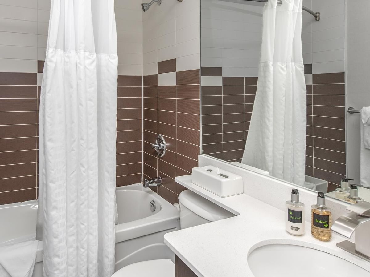 Bathroom with a bathtub, sink, and toilet.