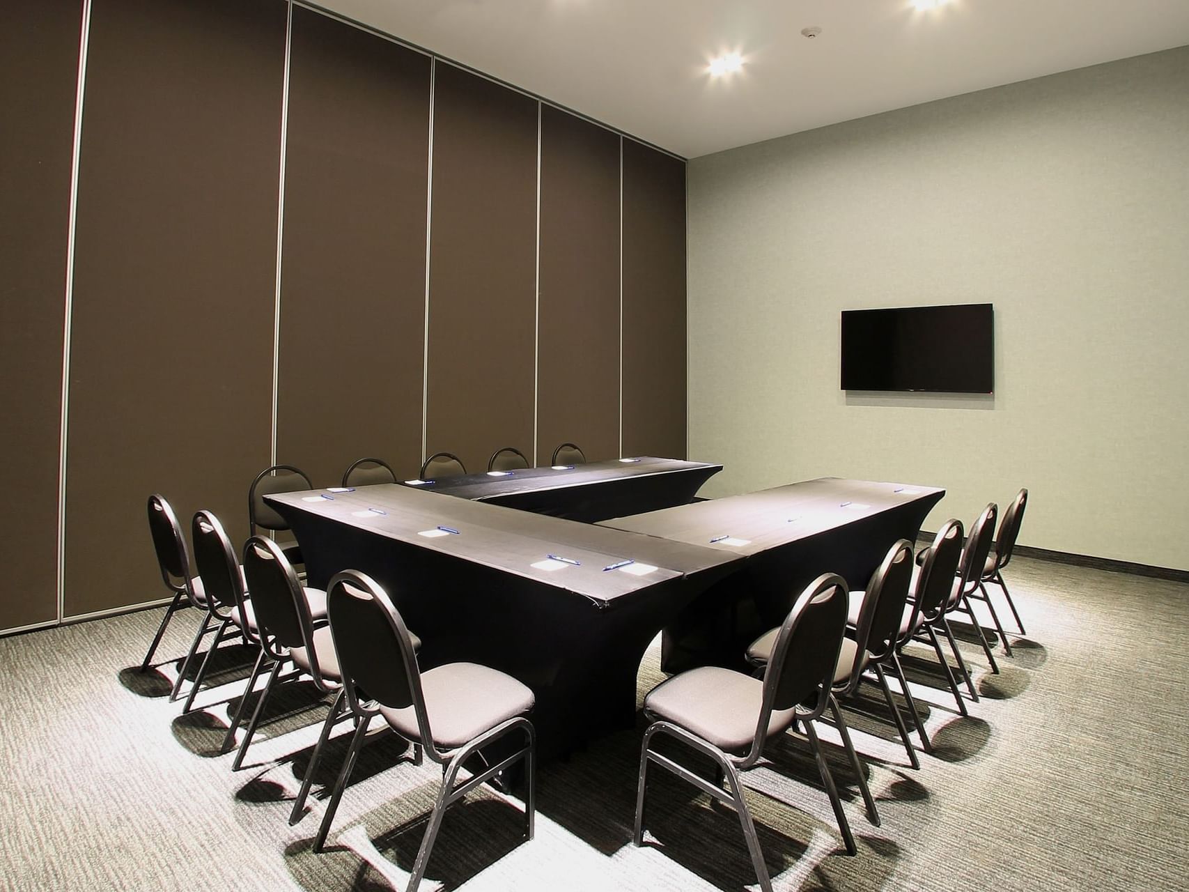 U-style meeting table arranged in a meeting room at One Hotels