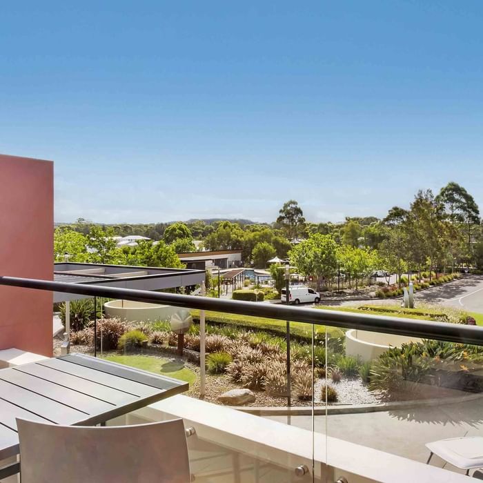 View from a Standard Room balcony overlooking a landscaped area with trees at Mercure Kooindah Waters