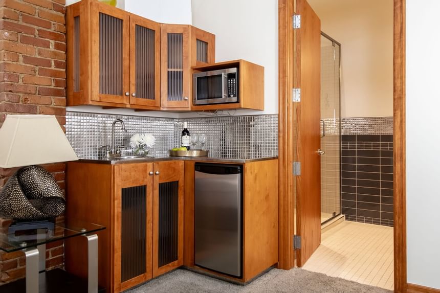 Kitchenette with pantry, appliances & wine bottle in King Superior Refresh at Retro Suites Hotel
