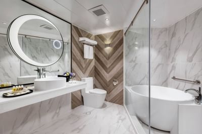 Bathroom with a marbled interior in Deluxe Suite at Park Hotel Hong Kong