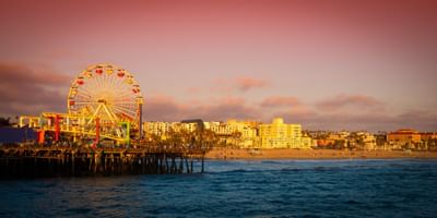 Santa Monica Pier lit up at sunset