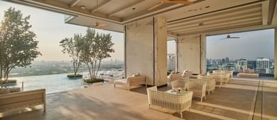Lounge area near the swimming pool with city view at Eastin Hotels