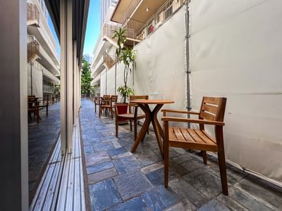 Patio area with lounge chairs & tables at Stay Hotel Waikiki