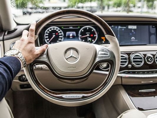 A hand on Steering wheel of a car at Lake Buena Vista Resort Village & Spa