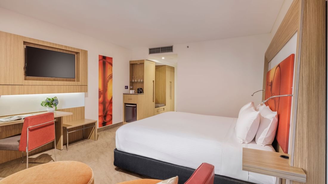 TV, work desk, and Coffee Station by the comfy bed in Superior Room at Novotel Sydney Olympic Park