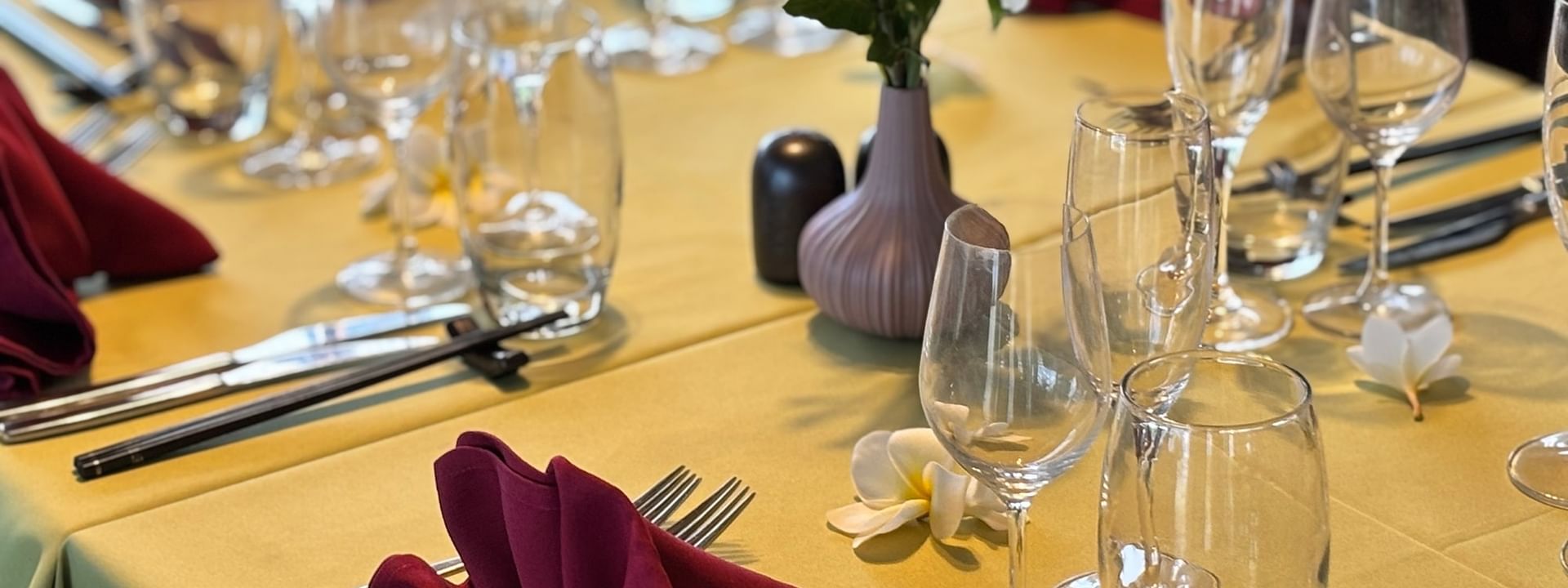 Elegantly set dining table with napkins and wine glasses at Wild Ginger Restaurant & Bar in Efate at Warwick Le Lagon - Vanuatu.