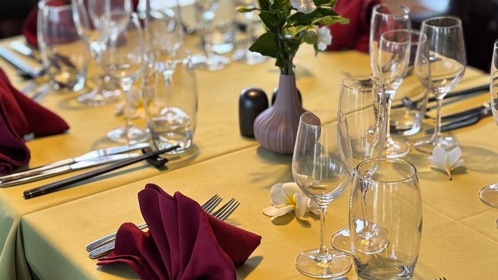 Elegantly set dining table with napkins and wine glasses at Wild Ginger Restaurant & Bar in Efate at Warwick Le Lagon - Vanuatu.