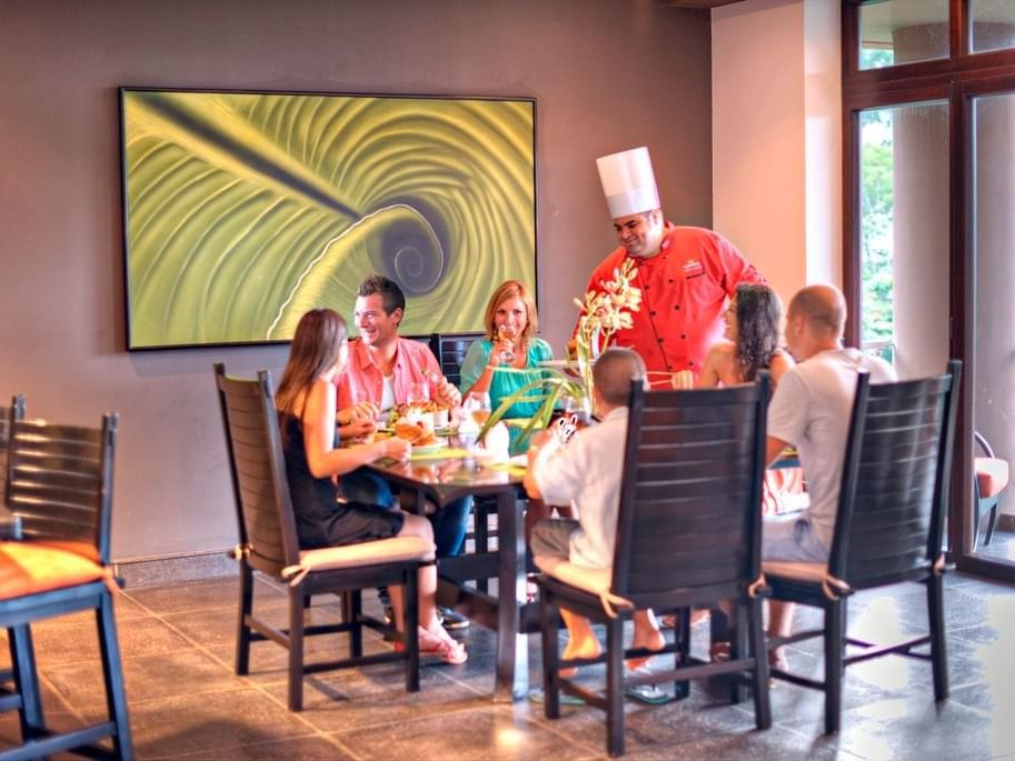 People happily enjoy meals in a restaurant at Los Altos Resort