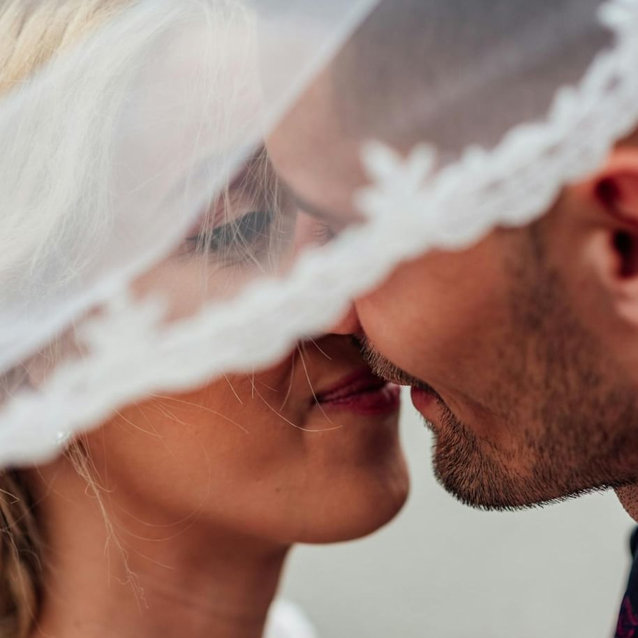 Close-up look of bride and groom kissing each other at The Terraces Resort & Spa