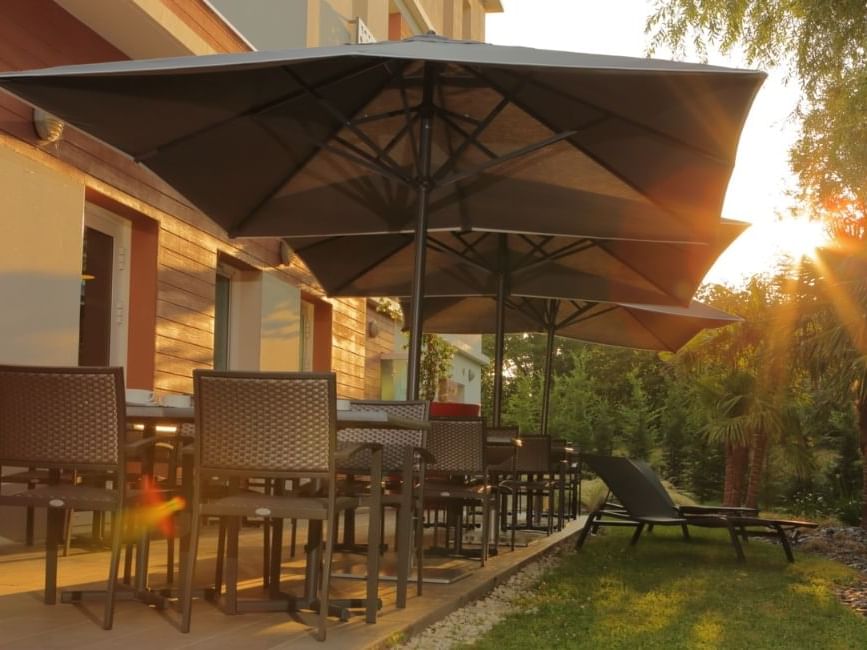 An outdoor lounge area with canopies at Originals Hotel