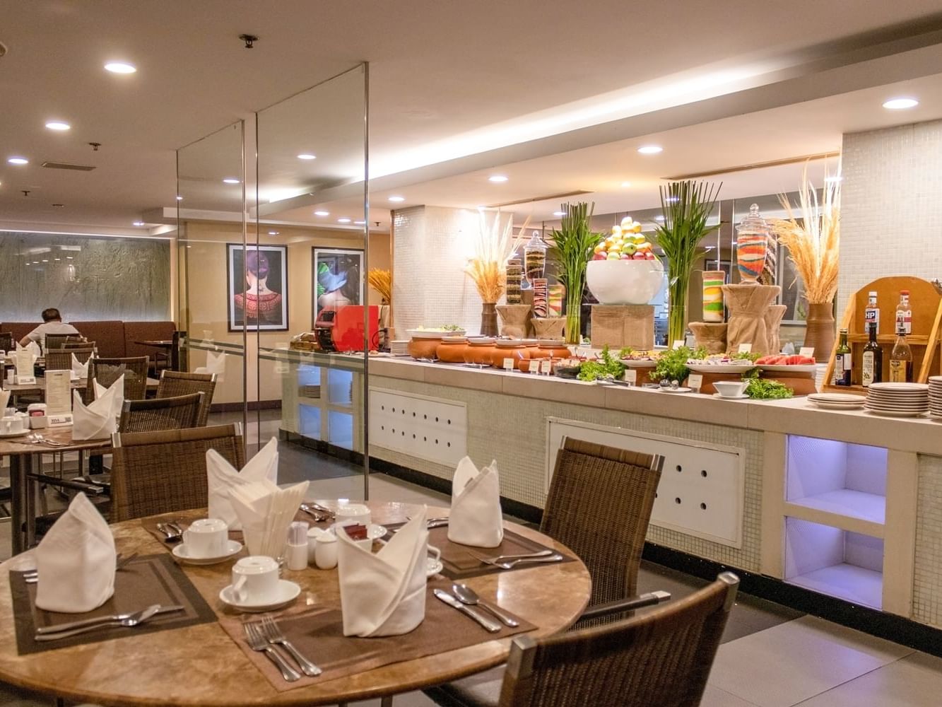 Buffet setup with a variety of food and neatly arranged tables in Cafe Saigon at Eastin Grand Hotel Saigon