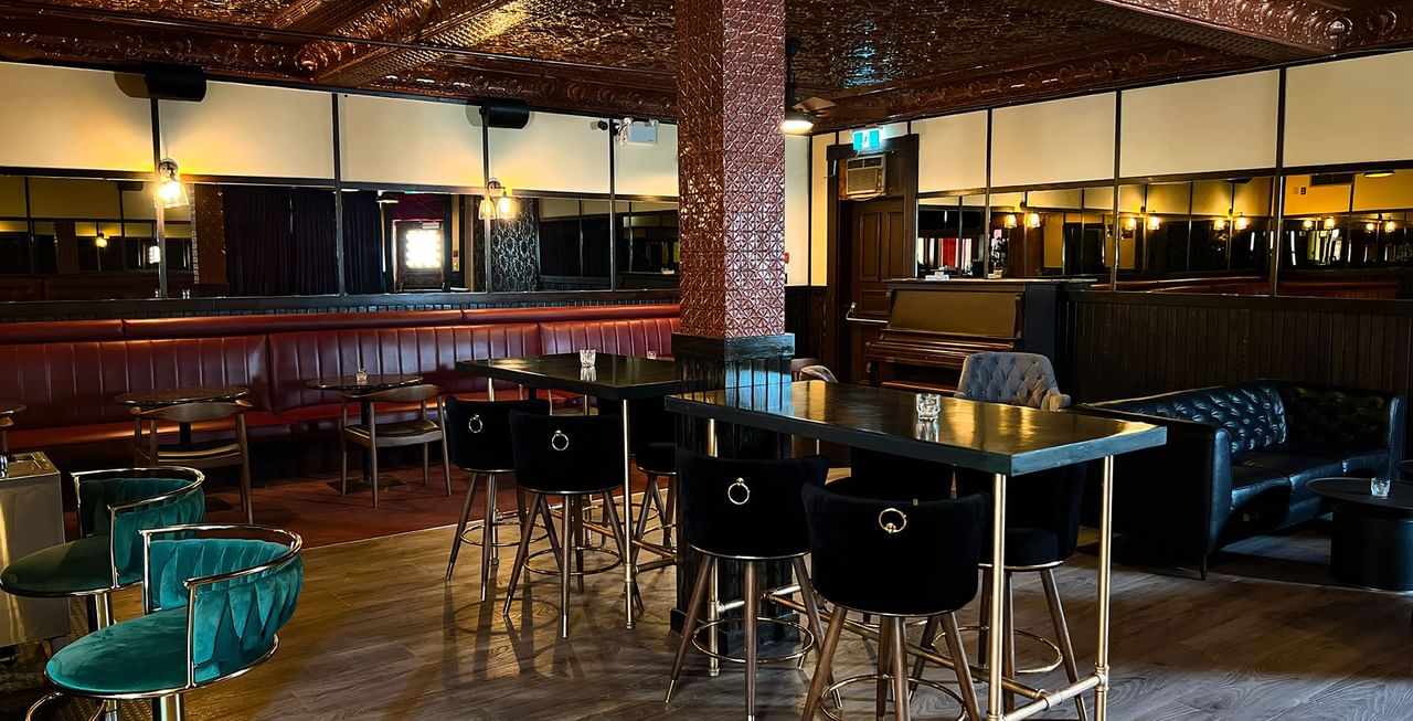 Dining tables arranged in a restaurant at Midnight Sun, a Coast Hotel