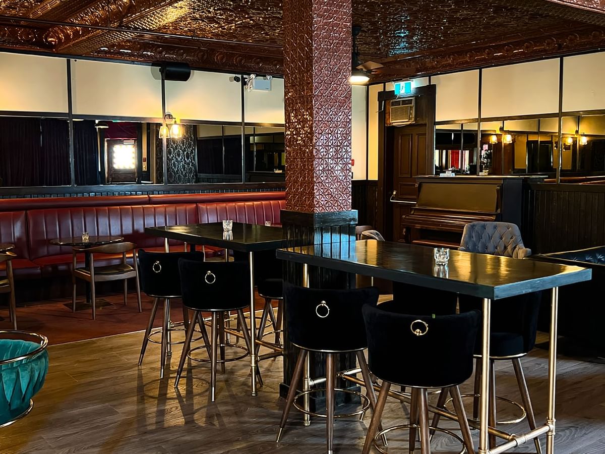 Dining tables arranged in a restaurant at Midnight Sun, a Coast Hotel