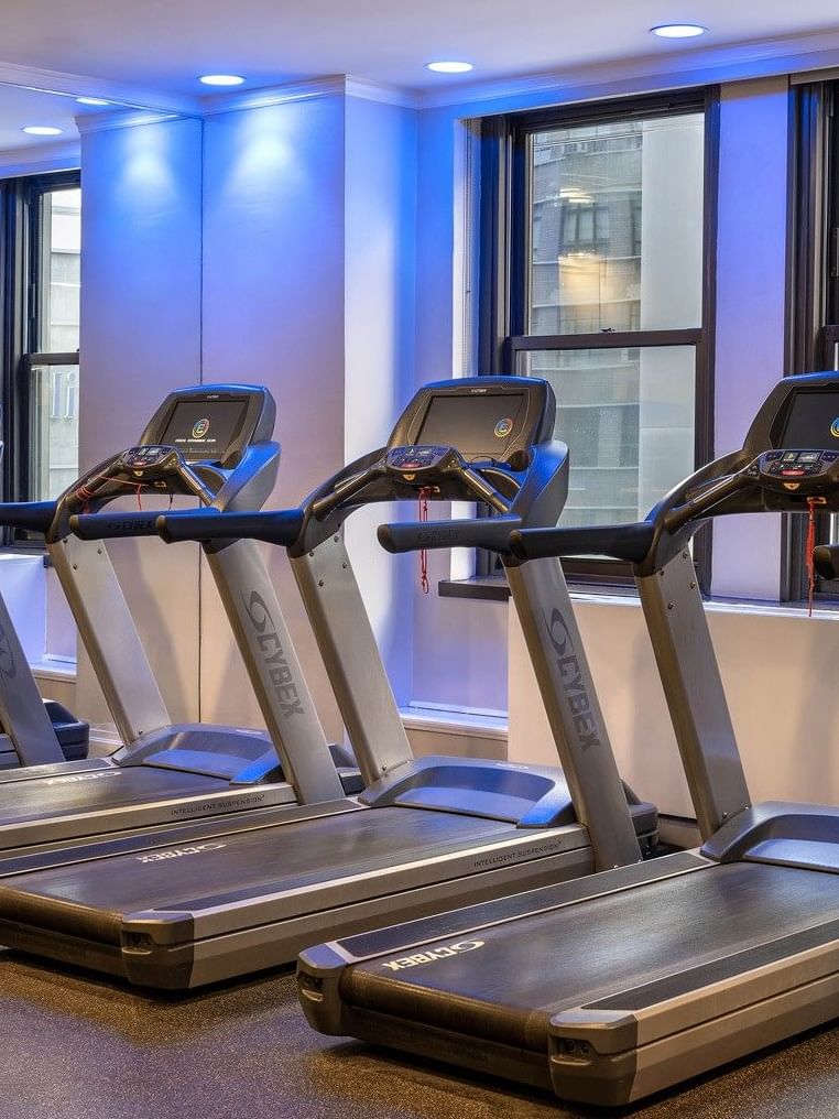 Row of treadmills and stationary bike in the fitness center at Warwick Hotels and Resorts