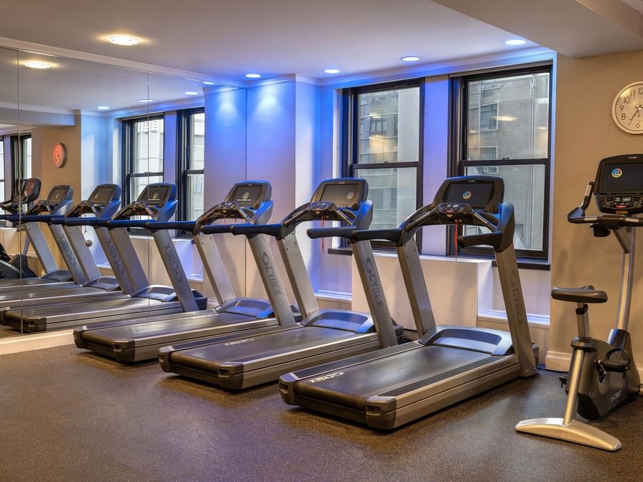 Row of treadmills and stationary bike in the fitness center at Warwick Hotels and Resorts