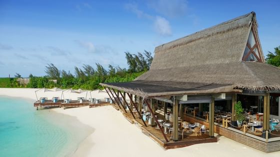 Exterior of The Edge with thatched roofs, overlooking the beach at Grand Park Kodhipparu, Maldives