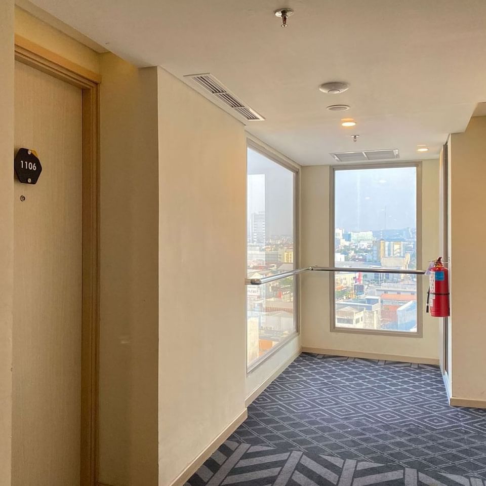 Hallway with city view at LK Pemuda Semarang Hotel & Residences