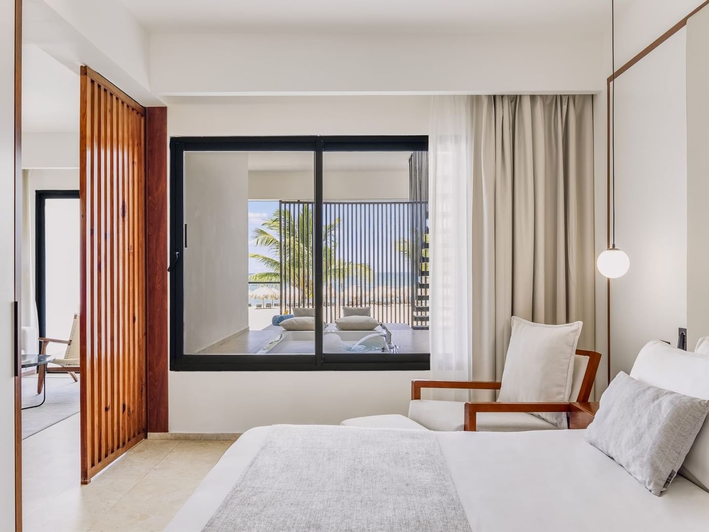 Viento Suite with a king bed in the bedroom by the living area at Live Aqua Punta Cana