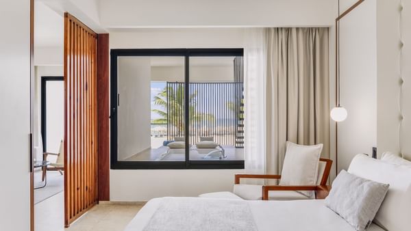 Viento Suite with a king bed in the bedroom by the living area at Live Aqua Punta Cana