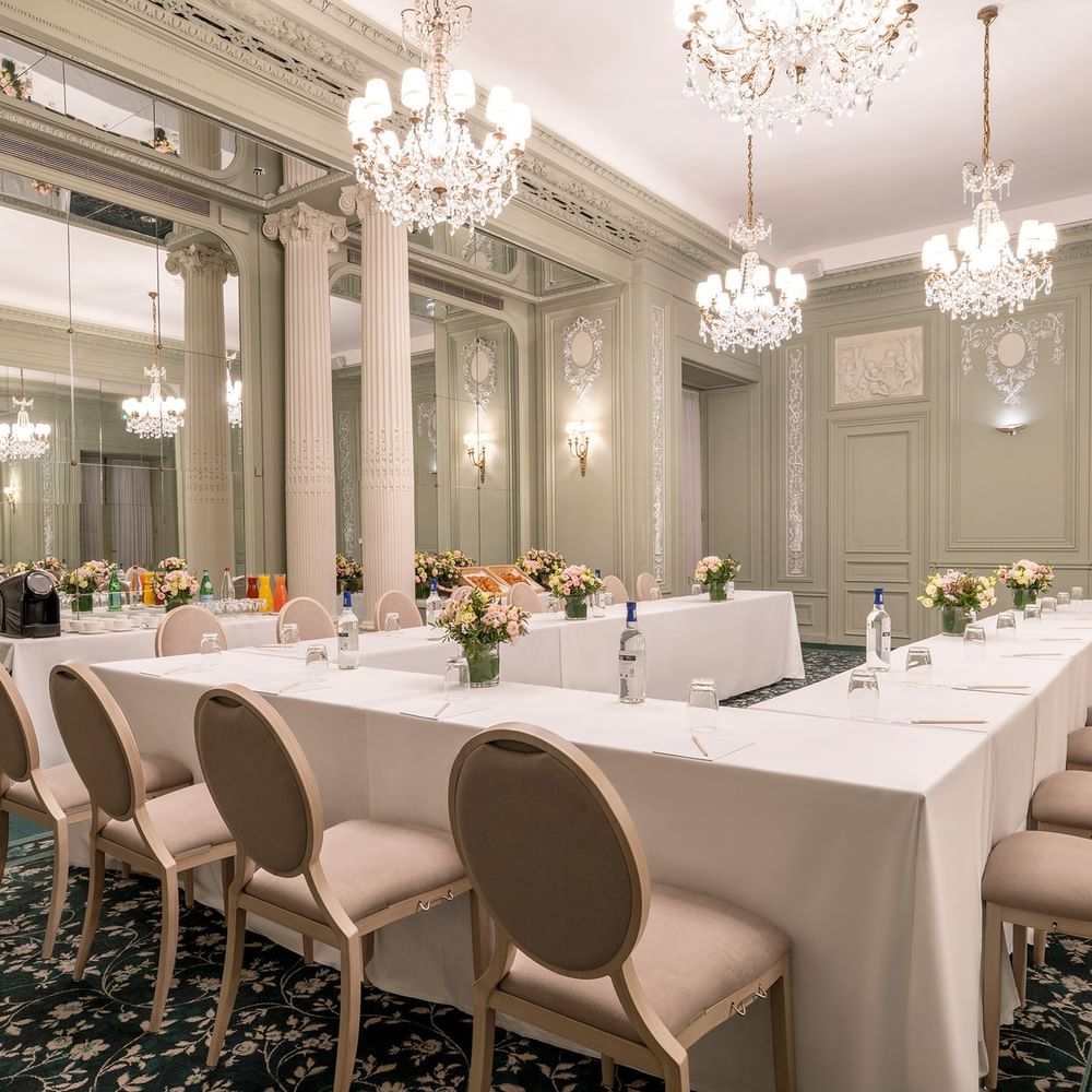U-shaped table setup, with chairs arranged under gold chandeliers in Récamier Meeting Room at Hotel Westminster Paris