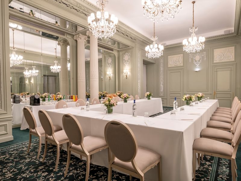 U-shaped table setup, with chairs arranged under gold chandeliers in Récamier Meeting Room at Hotel Westminster Paris