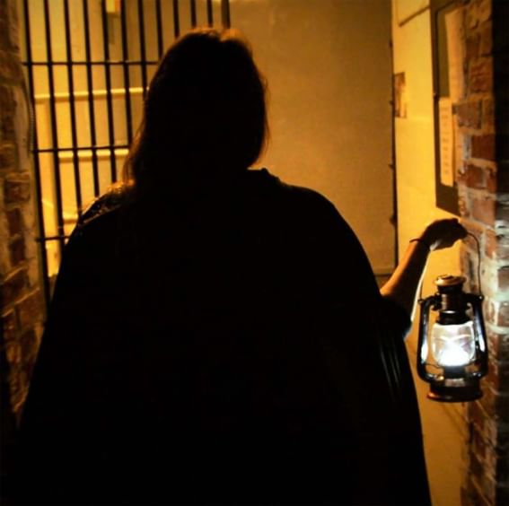 A woman walking with an old lamp in hand at ReStays Ottawa