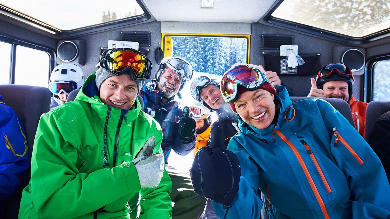 skiers smiling inside a cat ski machine in Revelstoke BC