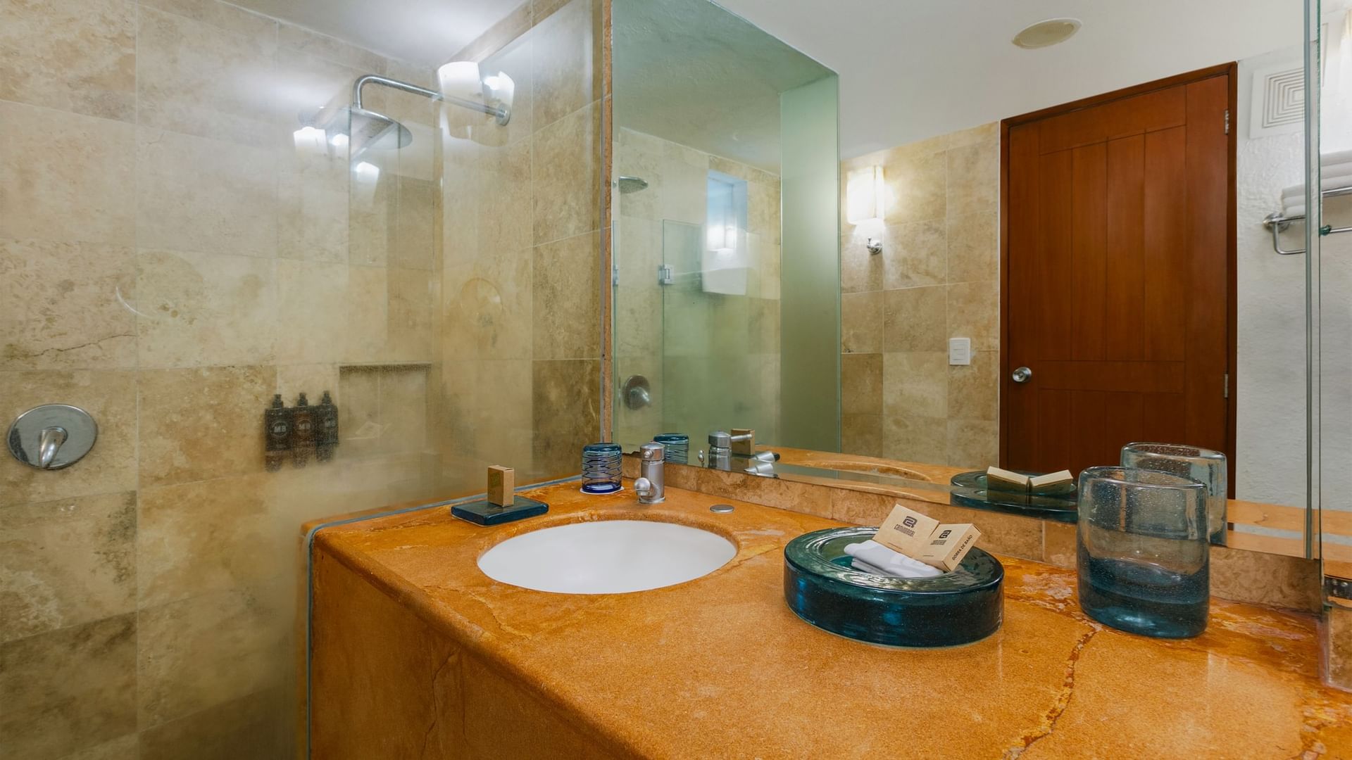 Elegant bathroom with tiled walls, large sink, and shower at Camino Real Guadalajara in Zapopan.