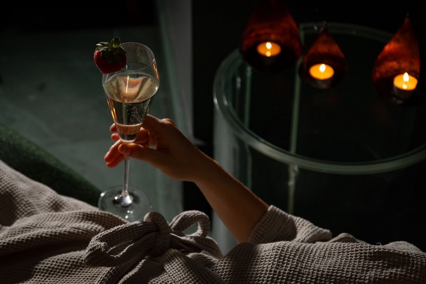 A man holding a Champagne glass in May Fair Spa at The May Fair Hotel