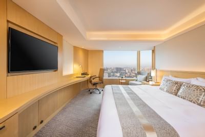 A Wall fixed TV by the bed in Standard room at White Swan hotel