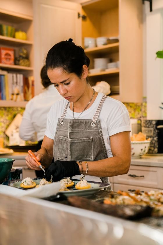 Chef Fernanda Tapia plating a dish