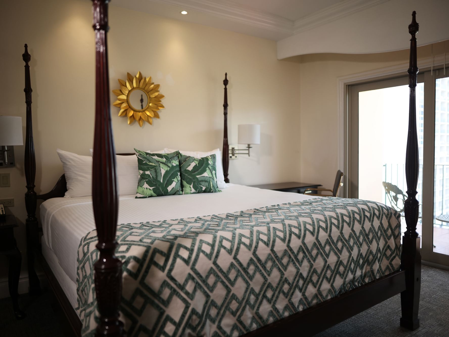 King-size bed by the balcony view in the Penthouse Deluxe at Courtleigh Hotel and Suites
