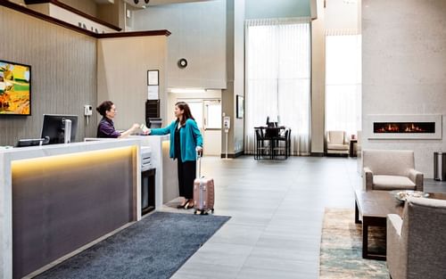 Woman checking in to hotel
