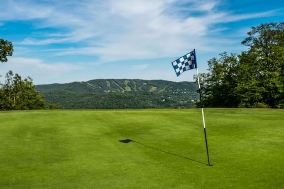 Flagstick in the golf course at Hotel Mont Gabriel Resort & Spa