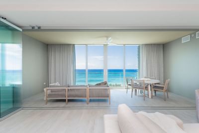 Lounge area with floor-to-ceiling windows overlooking a stunning ocean view in N701 at The Residences at Seafire