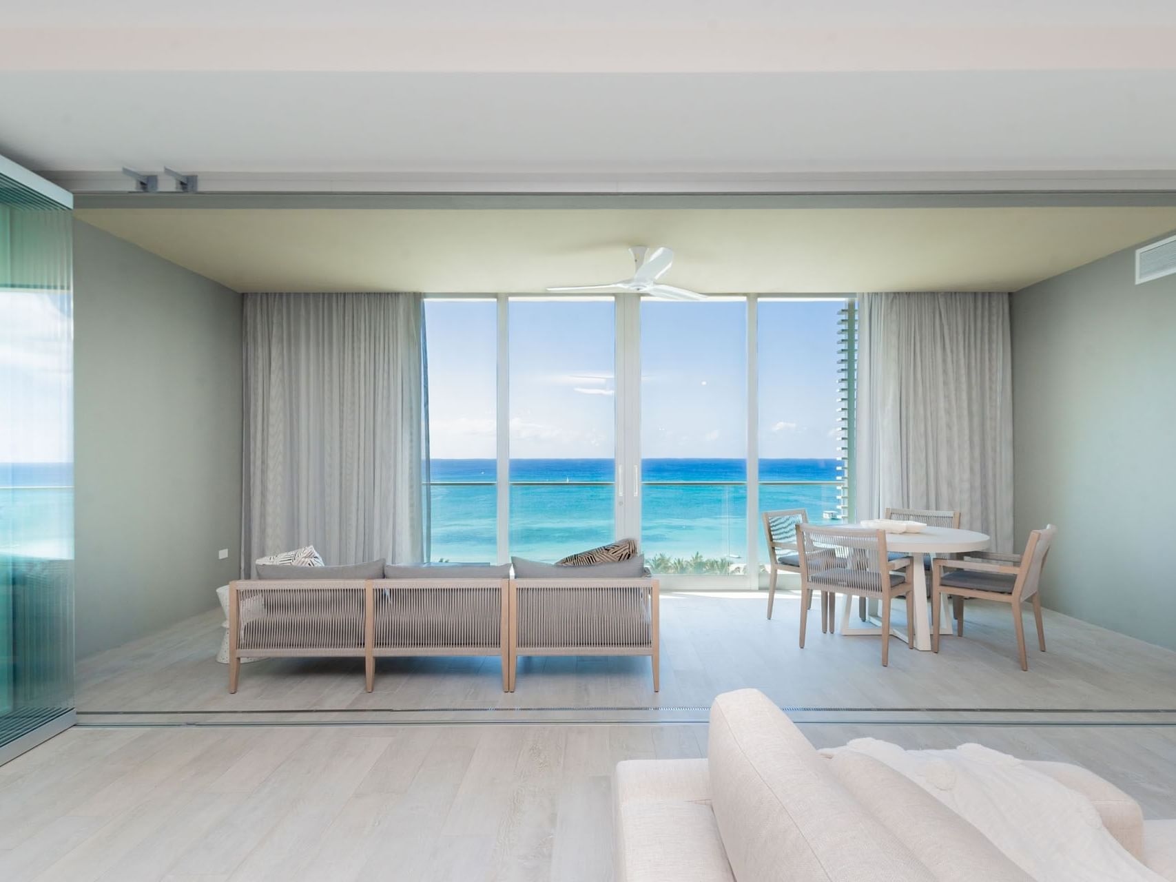Living area with dining table and ocean views in N701 Room at The Residences at Seafire.