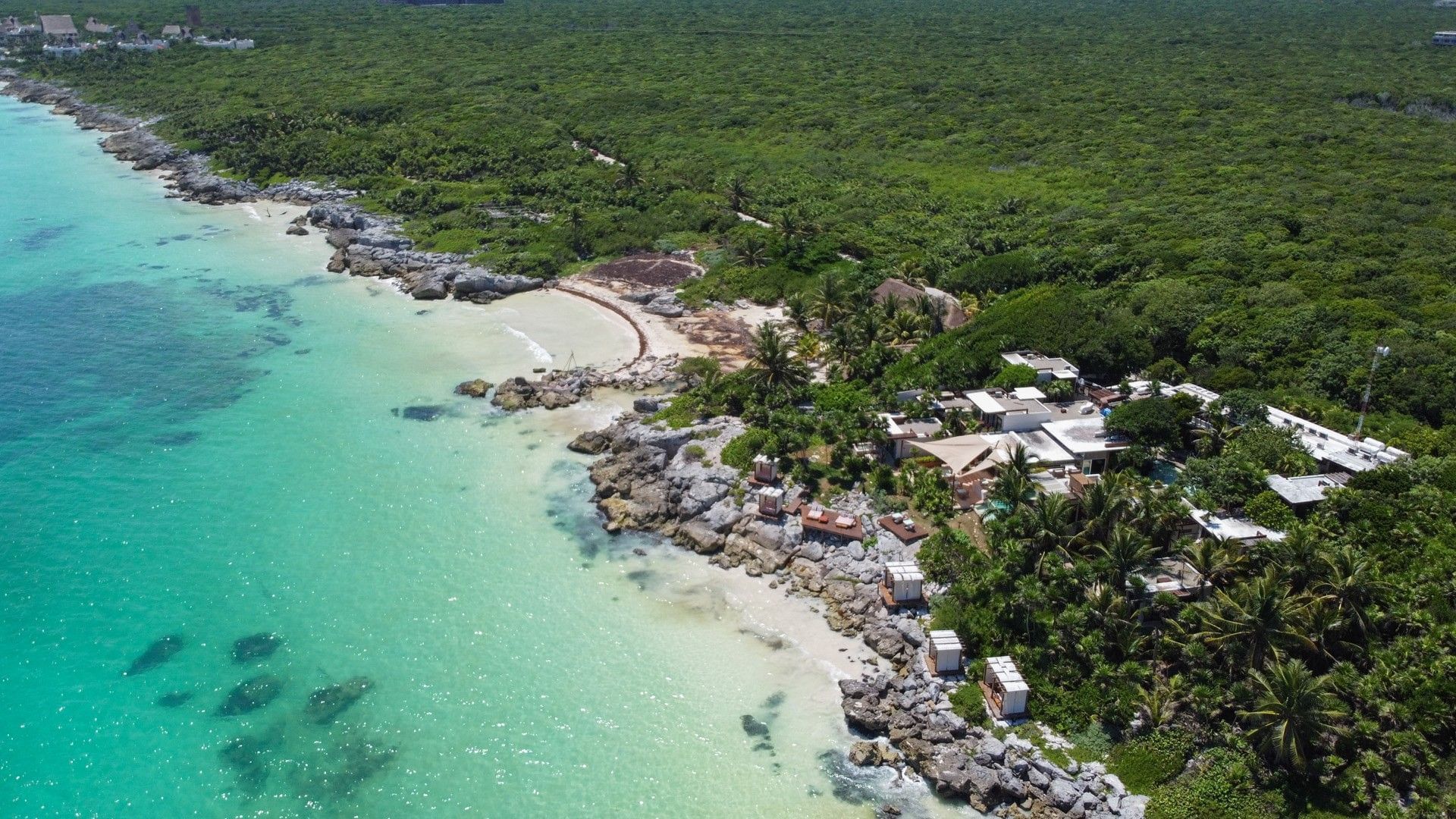 Aerial view of Mi Amor between tropical jungle and the Caribbean Sea