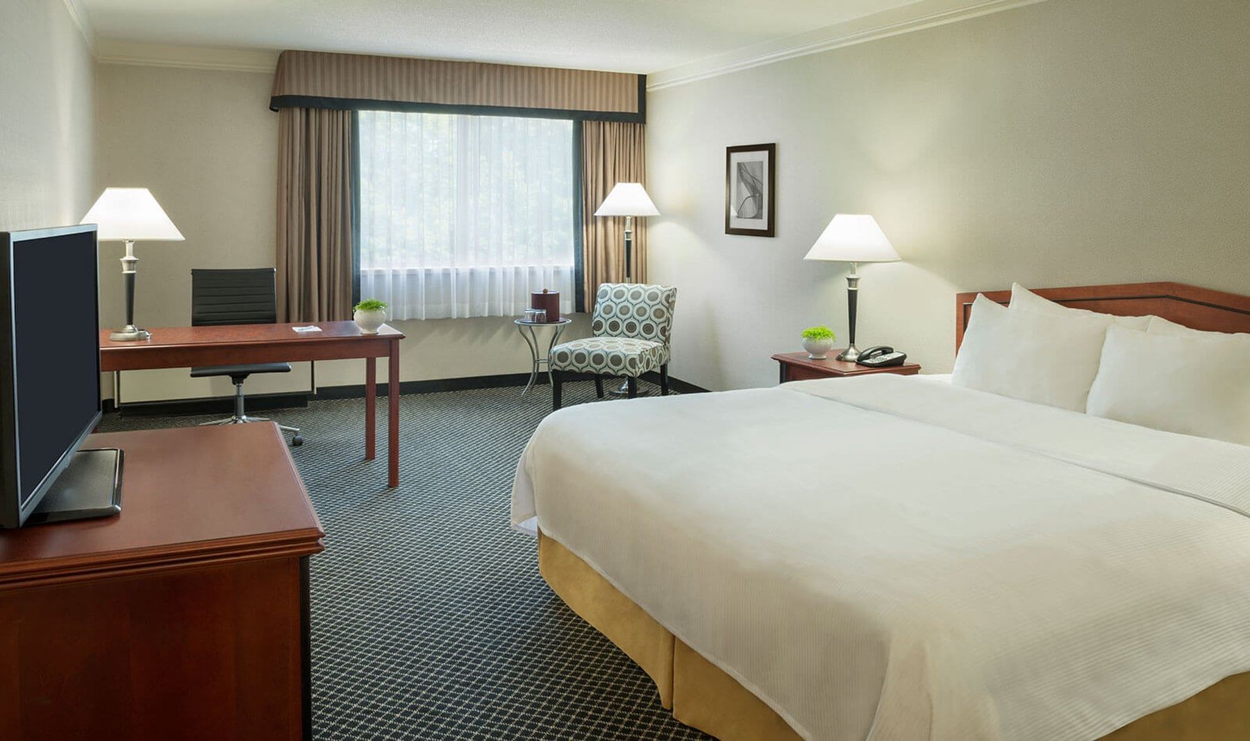 King bed in cozy hotel room