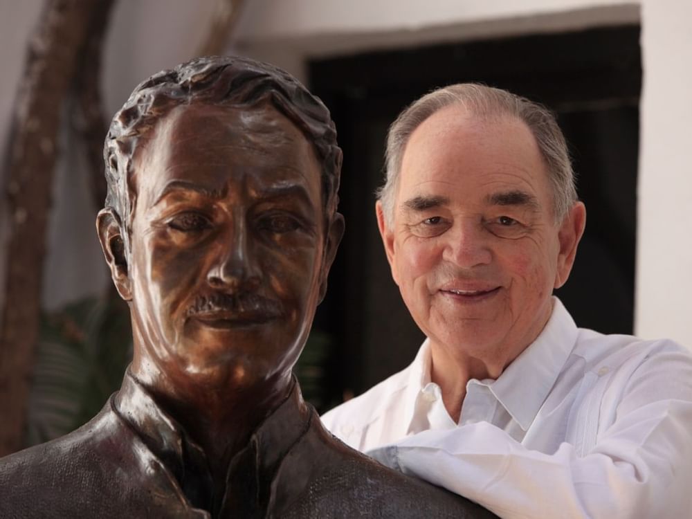 Headshot of a man posing near a statue at Marbella Club Hotel