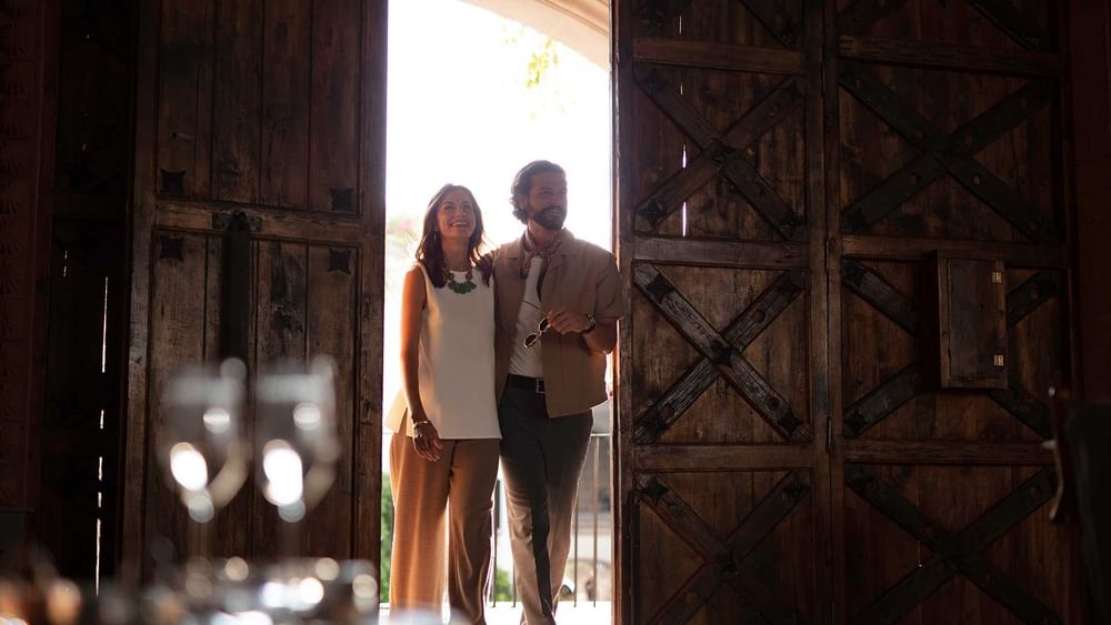 Couple walking through barn doors at Live Aqua Resorts and Residence Club