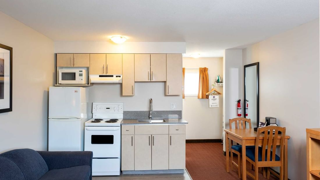 View of the kitchenette area, featuring microwave, coffee machine and fridge