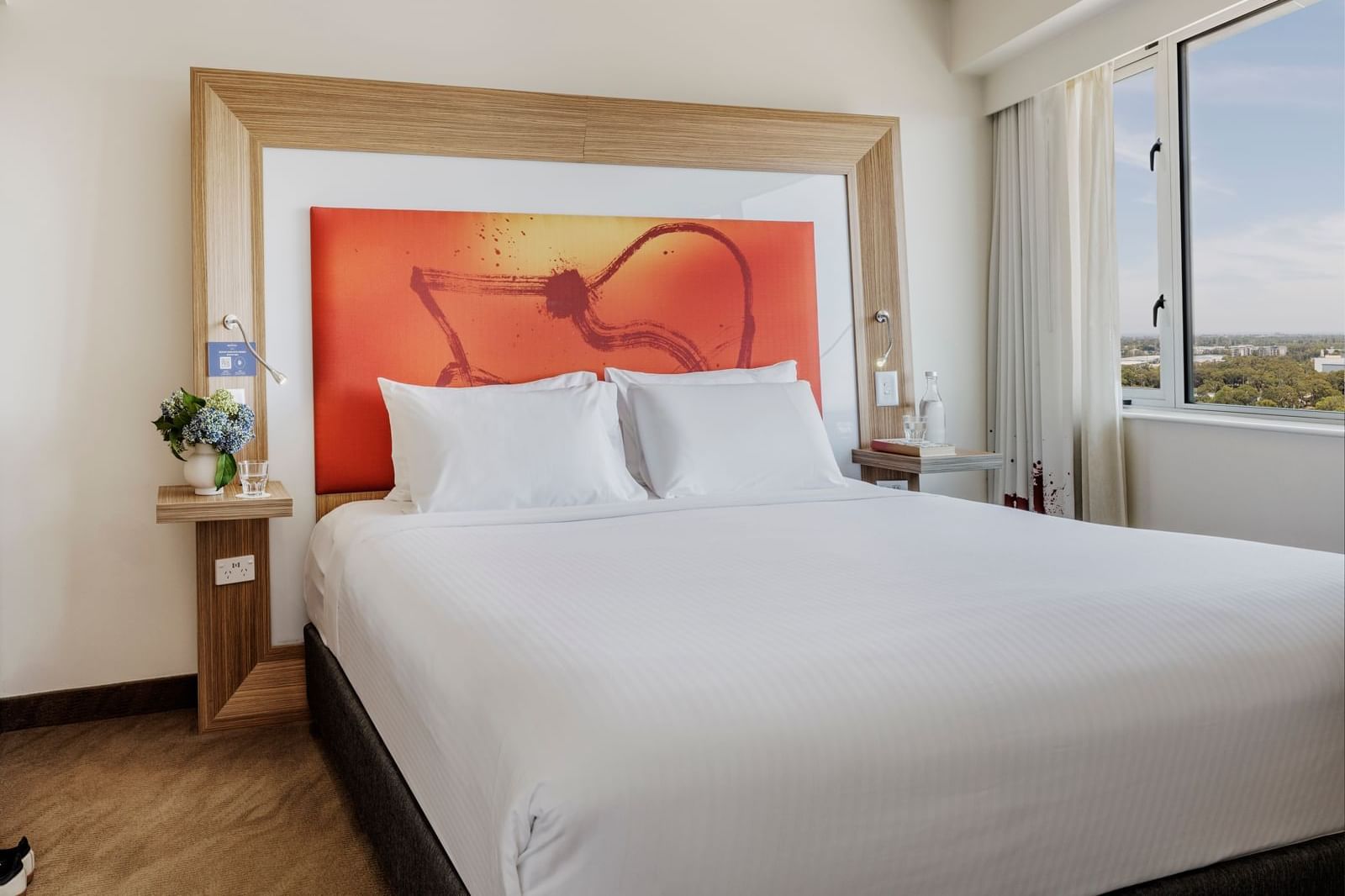 Spacious Superior Spa Suites with a plush king size bed and a vibrant, stylish headboard at Novotel Sydney Olympic Park