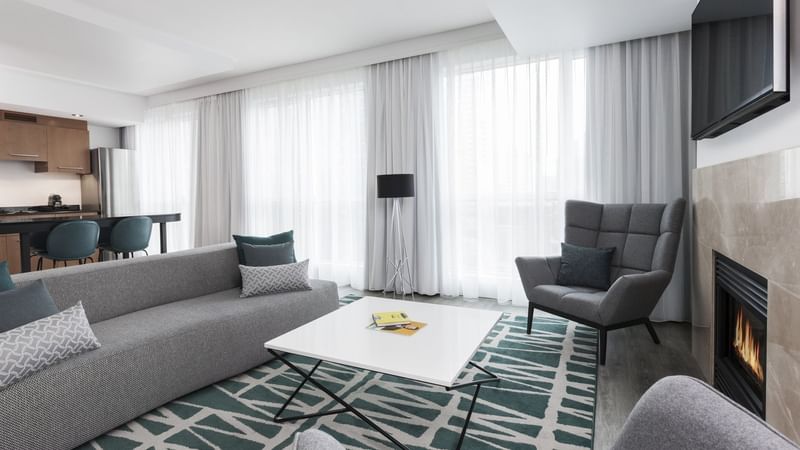 Living space with fireplace and comfy chairs in Penthouse Crescent at Warwick Le Crystal