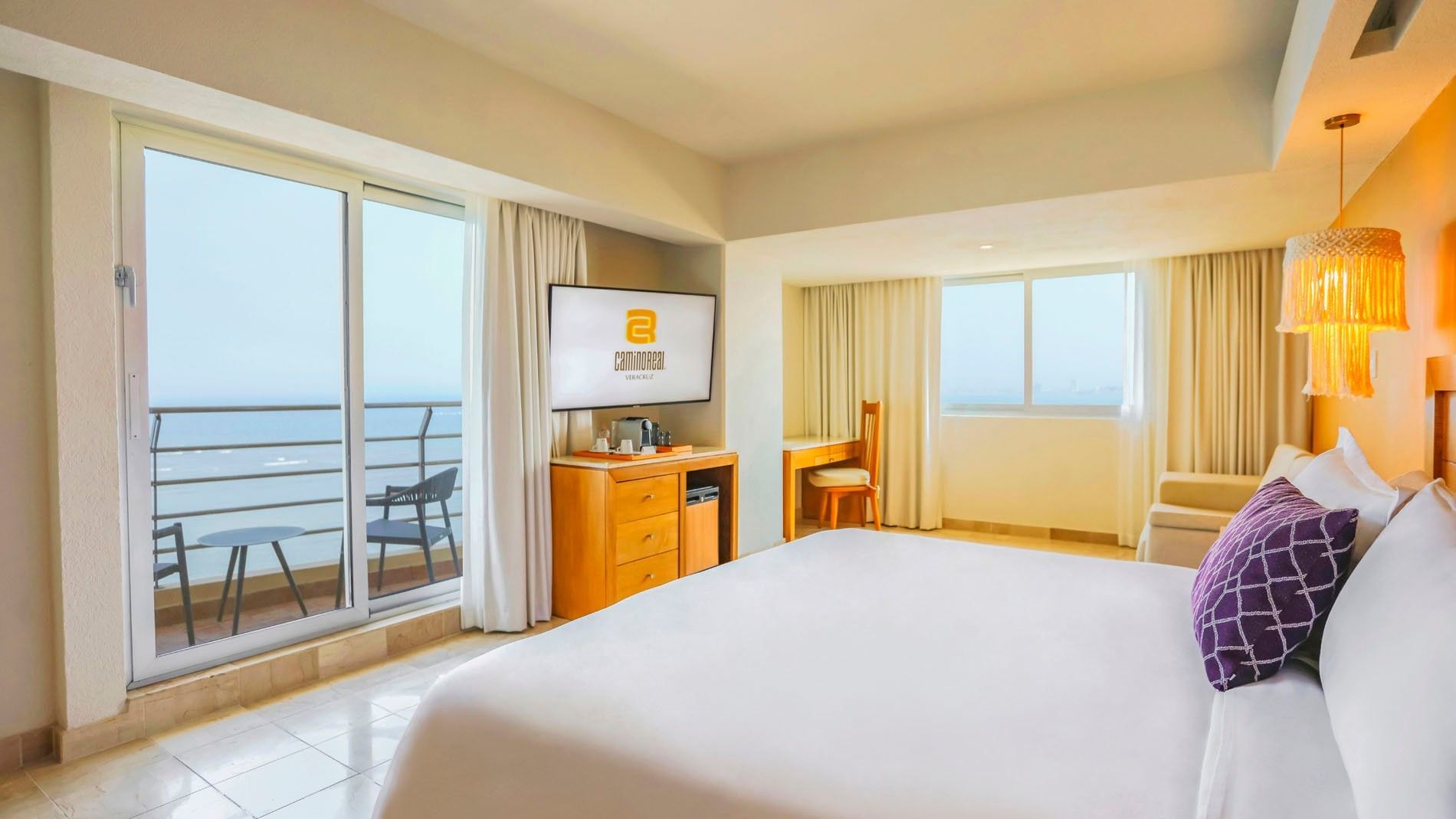 King Junior Suite layout with a balcony overlooking the water and a separate desk workspace at Camino Real Veracruz