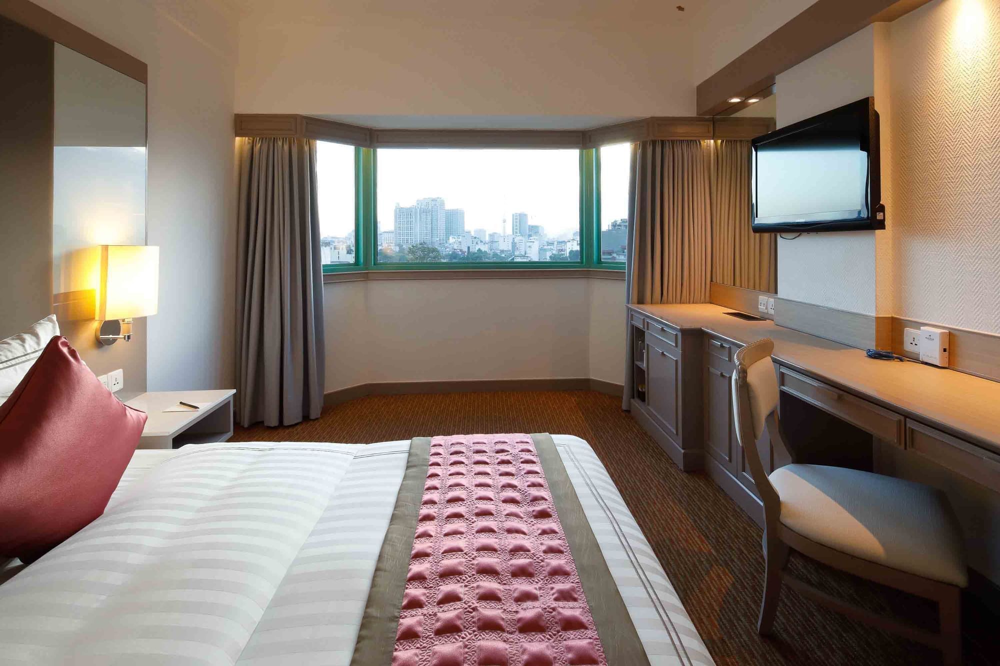 Cozy bed with TV & work area in Club City View King at Sunway Hotel Hanoi