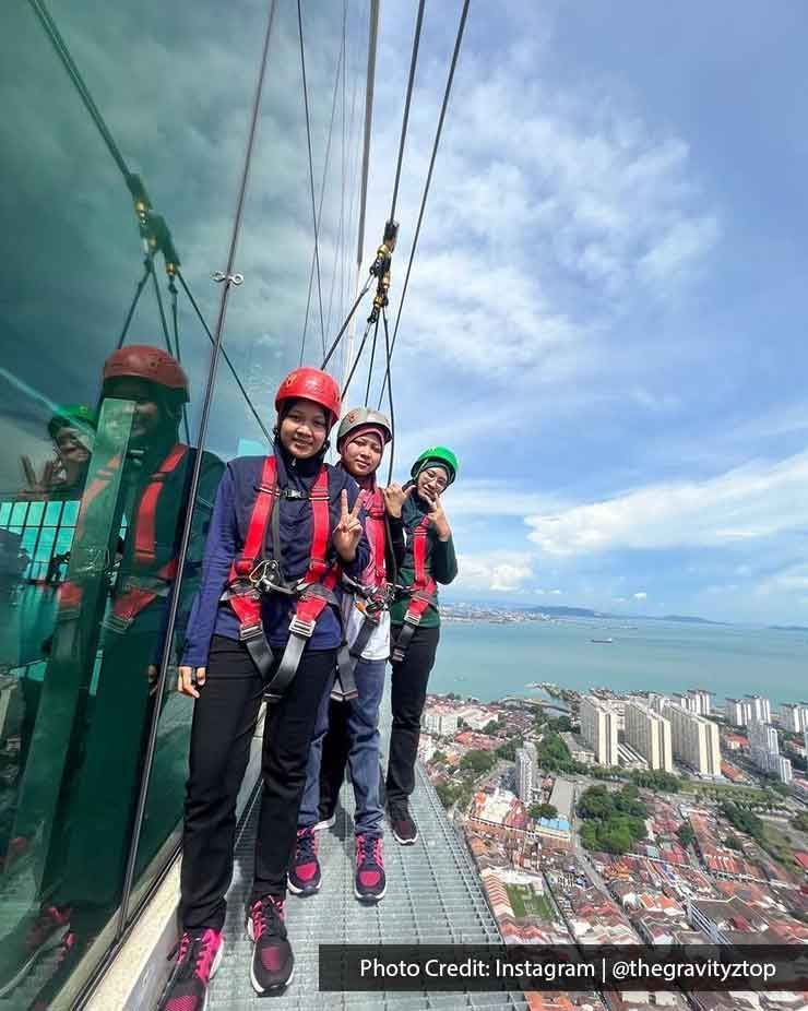 Three women were engaging in the high-rope course activity in The Gravityz - Lexis Suites Penang