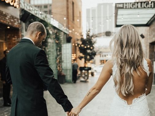 Newlywed couple walking on a sidewalk near Dream Hollywood LA
