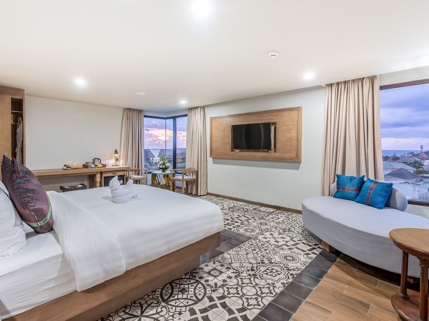 Cozy bed, TV & lounge area in Two Bedroom Suite at Eastin Ashta Resort Canggu